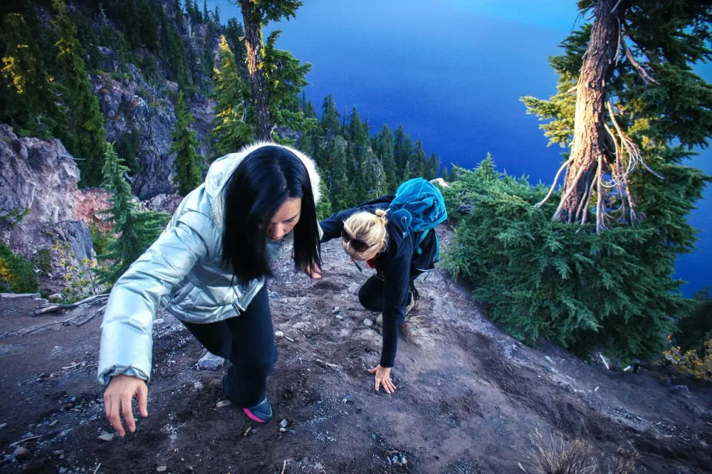 two girls climbing mountain